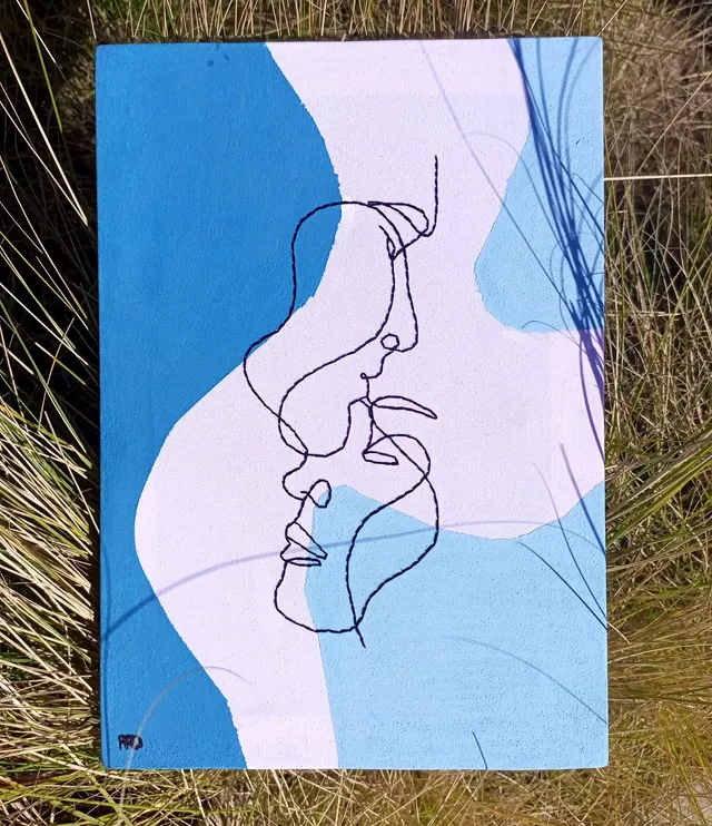 "Serenade of Love: Embroidered Embrace on a Blissful Blue Canvas"